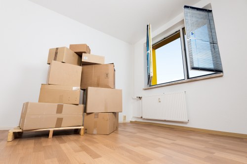 Movers carrying boxes and furniture during a same day removal in Tooting