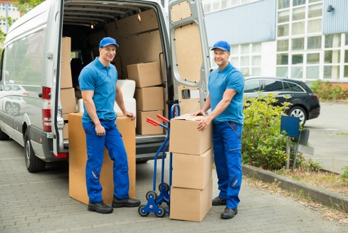 Staff using safe lifting methods during a house move